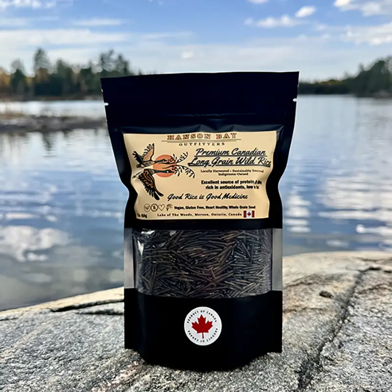 One-pound package of Hanson Bay Outfitters Canadian long grain wild rice beside Lake of the Woods